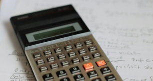 a-calculator-sitting-on-top-of-a-piece-of-paper.jpg a calculator sitting on top of a piece of paper